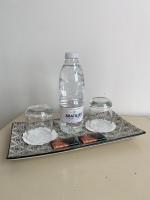 a bottle of water and two glasses on a tray at L&#39;Estanquet Bed and Breakfast pdj offert in Gastes