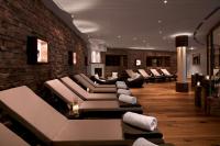 a living room with couches and a brick wall at Grand Tirolia Kitzbühel - Member of Hommage Luxury Hotels Collection in Kitzbühel