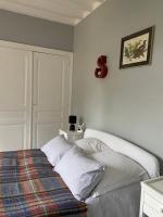 a bedroom with a bed with a blanket on it at Suite&amp;Caux 1 in Cany-Barville