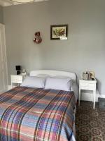 a bedroom with a bed and two white tables at Suite&amp;Caux 1 in Cany-Barville