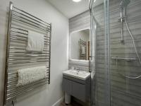 a bathroom with a sink and a shower at Westward 14 Polzeath in Polzeath