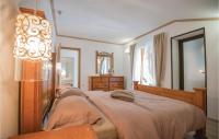 a bedroom with a large bed and a mirror at Stunning Home In Vinjani Donji With 5 Bedrooms, Wifi And Outdoor Swimming Pool in Majići