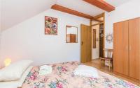 a bedroom with a bed and a wooden cabinet at Stunning Apartment In Delnice With Wifi in Delnice