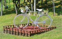 a white bike parked in a flower garden at Amazing Home In Vinica With Wifi in Vinica