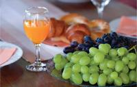 a plate of grapes and a glass of orange juice at Amazing Home In Vinica With Wifi in Vinica