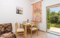 a dining room with a table and chairs and a window at Awesome Apartment In Rijeka With Wifi in Rijeka