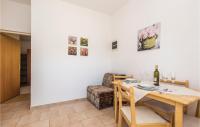 a dining room with a table and a chair at Awesome Apartment In Rijeka With Wifi in Rijeka