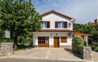 a white house with a tree and a driveway at Beautiful Apartment In Rukavac With Wifi in Rukavac