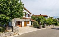 a white house with a tree on the side of a street at Beautiful Apartment In Rukavac With Wifi in Rukavac