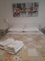 A bed or beds in a room at SoleLuna Fiera 6 Rooms