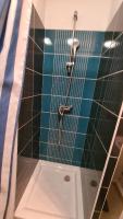 a shower in a bathroom with a blue tiled wall at Logesty Studio Cosy316 in Perpignan