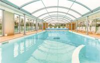 a large swimming pool with a glass ceiling at Le Hameau De Peemor Pen in Morgat