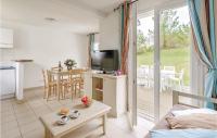 a living room with a television and a table at Le Hameau De Peemor Pen in Morgat