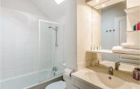 a bathroom with a sink and a toilet and a shower at Le Hameau De Peemor Pen in Morgat