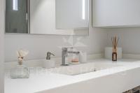 a white bathroom with a sink and a mirror at Paula by Terry&#39;s Homes in Cannes