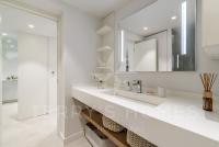 a white bathroom with a sink and a mirror at Paula by Terry&#39;s Homes in Cannes