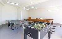 a ping pong table in a room with two tables at Cozy Home In Makarska With Kitchen in Makarska