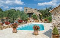 a swimming pool in front of a stone house with flowers at Awesome Home In Fontarches With 2 Bedrooms, Wifi And Outdoor Swimming Pool in Fontarèches