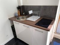 a small kitchen with a sink and a counter at Appartements VIZILLE GRENOBLE - Route Napoleon in Vizille
