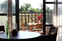 a table with a vase of flowers on a balcony at 大花紫薇田園民宿 in Ji&#39;an