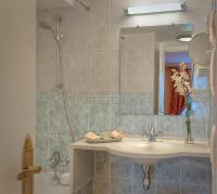 a bathroom with a sink and a shower at Hôtel de Varenne in Paris