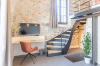 a staircase in a room with a desk and a chair at Les Tours Carrées in La Motte-Servolex