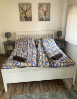 A bed or beds in a room at Mátrai Vadászház 3-Vintage Cottage