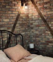 A bed or beds in a room at Mátrai Vadászház 3-Vintage Cottage