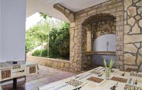 an outdoor kitchen with a stone wall at Awesome Apartment In Sv, Petar With 2 Bedrooms And Wifi in Sveti Petar