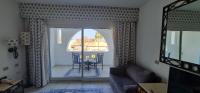 A seating area at Apartment at domina coral bay aquamarine , resort spa e casino'