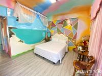 a bedroom with a mural of a bath tub at Hi Young Castle in Hengchun South Gate