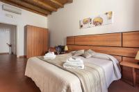 A bed or beds in a room at Salomone Apartments II by Wonderful Italy