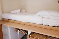 a bed sitting on top of a wooden shelf at STUDIO of 24m with small patio in Avignon
