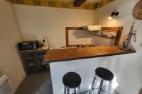 a kitchen with two bar stools and a counter top at STUDIO of 24m with small patio in Avignon