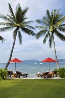 a group of chairs and umbrellas next to the ocean at Amari Phuket in Patong Beach