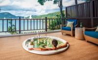 a woman laying in a bath tub on a floor at Amari Phuket in Patong Beach