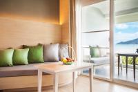 a living room with a couch and a table at Amari Phuket in Patong Beach