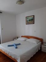 Postel nebo postele na pokoji v ubytování Apartments Grozdana