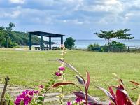 a park with a gazebo and flowers in a field at Fei Li Jin Hotel in Kenting