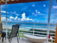 a bathroom with a tub and a view of the ocean at Fei Li Jin Hotel in Kenting