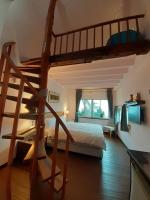 a bedroom with a bunk bed and a spiral staircase at Bridge12th B&amp;B in Yanliau