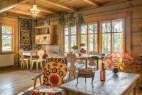 a dining room with a table and chairs and windows at Leśniczówka u Zięby in Kościelisko