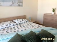 Postel nebo postele na pokoji v ubytování Apartament Jaśminowy Shiraz Gdynia