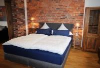 Postel nebo postele na pokoji v ubytování BluGarden Ferienapartments im Spreewald