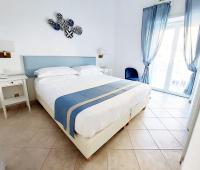 Postel nebo postele na pokoji v ubytování Hotel Guarracino