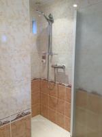 a shower with a glass door in a bathroom at Chambre &amp; Caux in Thiergeville