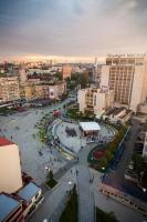 a city with a fountain in the middle of a street at Pristina Select Apartments in Pristina