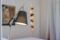 a lamp sitting on a bed in a room at Amélia Appartement Saint-Jorioz in Saint-Jorioz