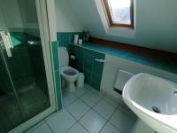a bathroom with a toilet and a sink and a shower at Gîte de l&#39;Hirondelle bleue in Brech