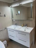 a bathroom with a white sink and a mirror at Chambre d hote au calme in Brétigny-sur-Orge